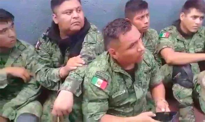 Some of the soldiers who were detained by civilians on Sunday in Michoacán.