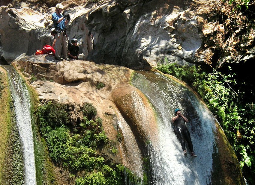 Sliding down a natural water slide in Aquetzalli canyon.