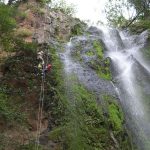 Father and daughter abseiling together at Nameless Falls.