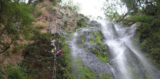 Father and daughter abseiling together at Nameless Falls.