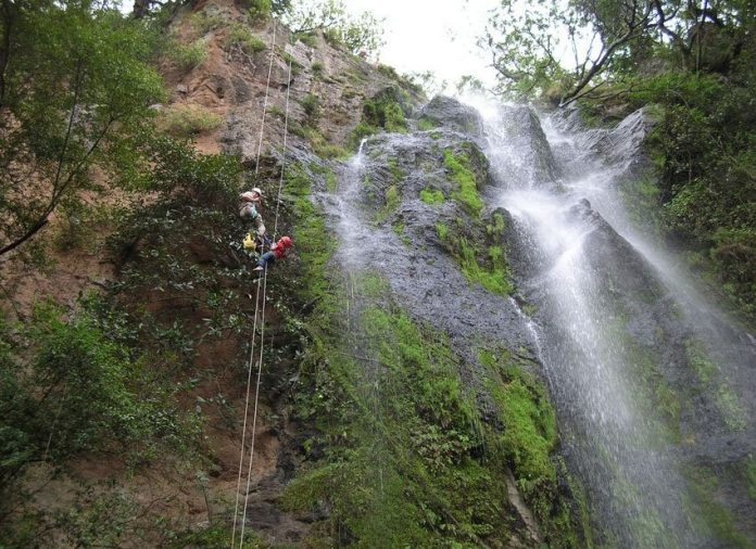 Father and daughter abseiling together at Nameless Falls.