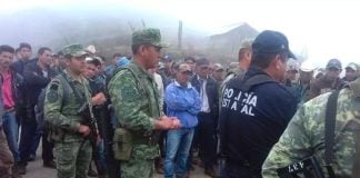 Soldiers, police and farmers in Heliodoro Castillo.