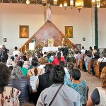 Supporters of jailed priest pray for his release.