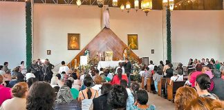 Supporters of jailed priest pray for his release.