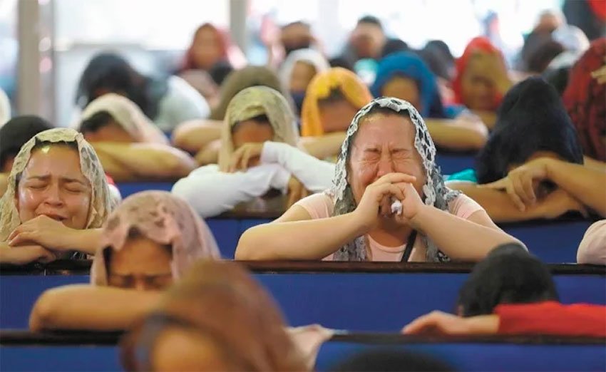 Followers in Guadalajara of La Luz del Mundo cry while praying for their leader.