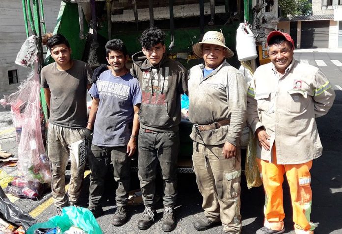 A Mexico City garbage truck crew.