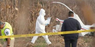 Investigators at the helicopter crash scene.