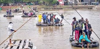 Rafts ferry migrants across the Suchiate river at the Mexico-Guatemala border.