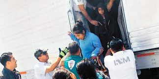 Migrants exit one of the trailers apprehended Saturday in Veracruz.