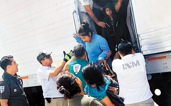 Migrants exit one of the trailers apprehended Saturday in Veracruz.