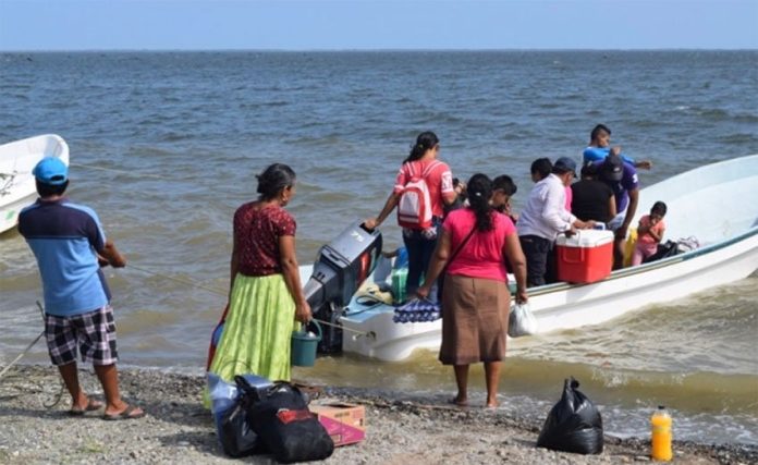 Santa María residents board a boat to reach their homes.