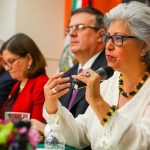 Ebrard, center, listens as Economy Secretary Graciela Márquez addresses the press conference.