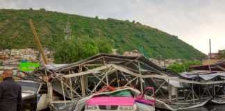The billboard squashed a taxi when it fell during wind and rain Thursday.