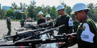 Soldiers destroy seized firearms.