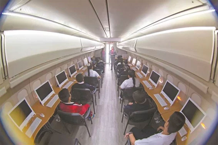 Computer terminals line either side of the fuselage.