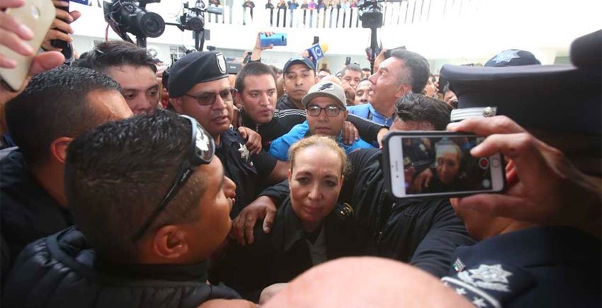Senior National Guard official Trujillo caught in the crush at Federal Police headquarters.