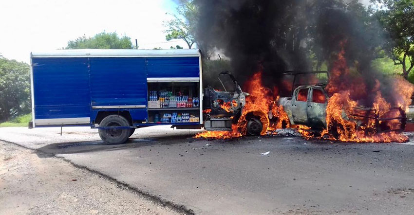 Vehicles burn at the National Front's Chiapas blockade.