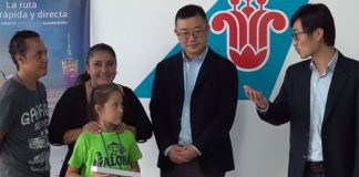 Samantha receives her ticket to China from airline representatives.