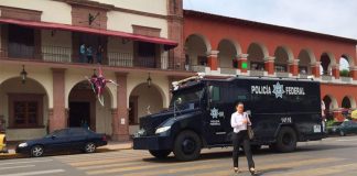 Police on patrol at the Apatzingán municipal palace in 2015.