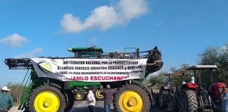 'Listen to us AMLO,' reads the sign on a farm vehicle at one of today's blockades.