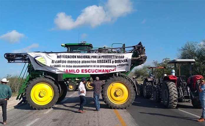 'Listen to us AMLO,' reads the sign on a farm vehicle at one of today's blockades.