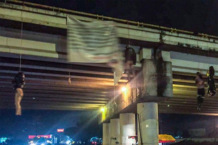Bodies hang from an overpass this morning with a narco-banner signed by the Jalisco New Generation Cartel.