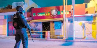 A police officer stands watch over the Coatzacoalcos crime scene.