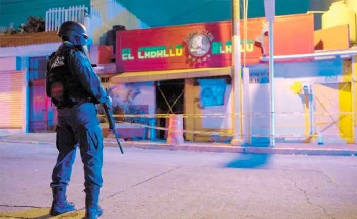 A police officer stands watch over the Coatzacoalcos crime scene.