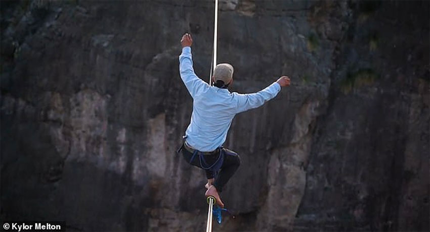 Corbin Kunst crosses the Rio Grande on a slackline.