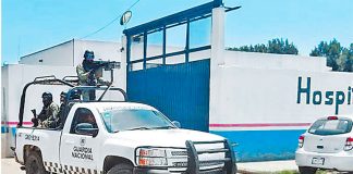 National Guard on patrol at a hospital where wounded hitmen were being treated after yesterday's gun battle.