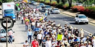 Landowners march to press for payment of what they claim is owed.