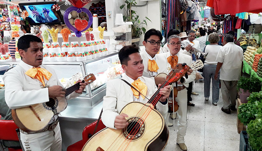 A mariachi band plays for the market's anniversary.