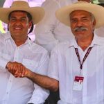 Undersecretary Peralta and self-defense force founder Mireles shake hands in La Huacana.