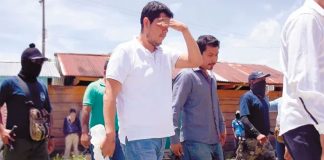 Flanked by masked socialist front members, police are set free.