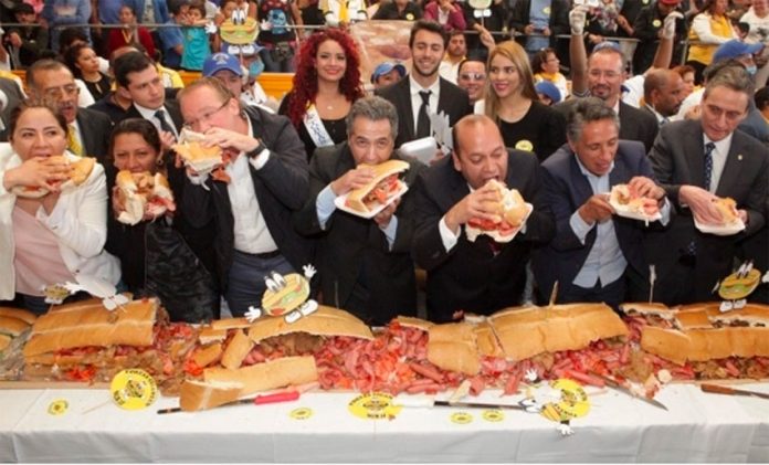 Officials chow down at the opening of Mexico City's Torta Fair.