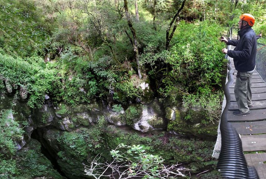 A hanging bridges gives a great view of a doline 85 meters deep.