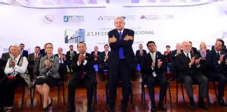 AMLO offers one of his trademark hugs at yesterday's conference.