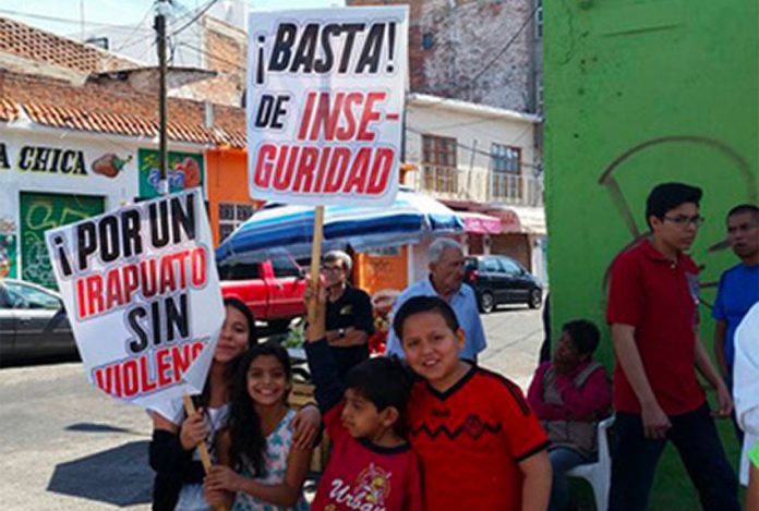 'Enough insecurity,' reads one of the signs at a protest in Irapuato.