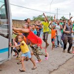 African migrants attempt to stop UN officials from leaving new registration center.