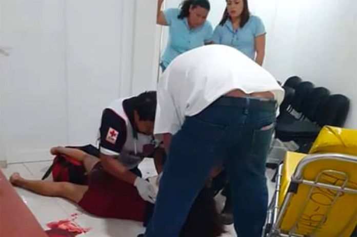Paramedic treats victim of knife attack.
