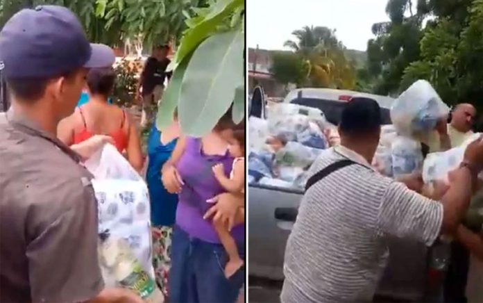 Presumed gang members hand out aid to storm victims in Jalisco.