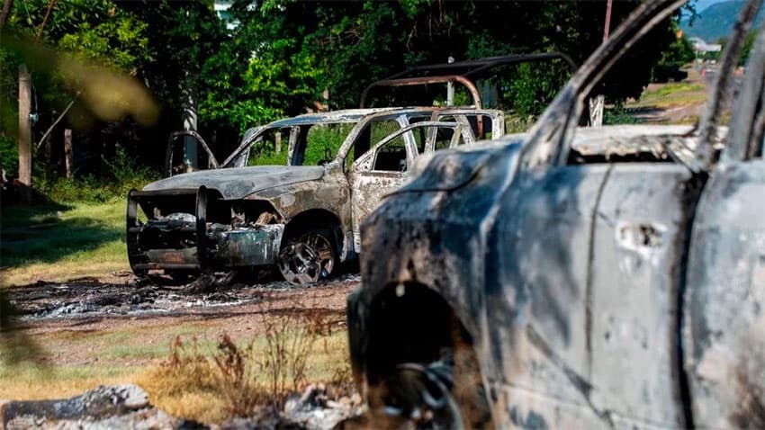 Burned police vehicles after the ambush in Aguililla.