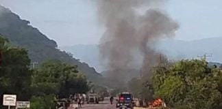 Police vehicles burn Monday morning in Aguililla, Michoacán.