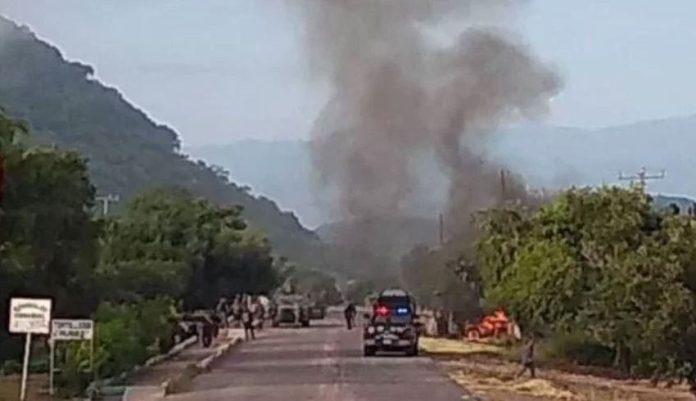 Police vehicles burn Monday morning in Aguililla, Michoacán.