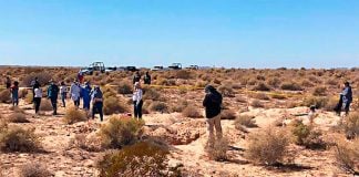 Searchers at the site where the bodies were found.