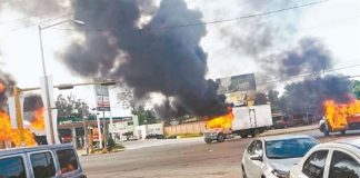 Burning vehicles block streets in Culiacán Thursday afternoon.