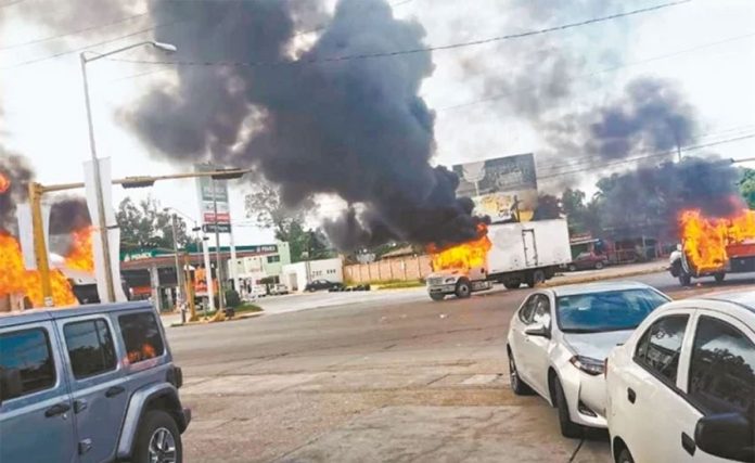 Burning vehicles block streets in Culiacán Thursday afternoon.