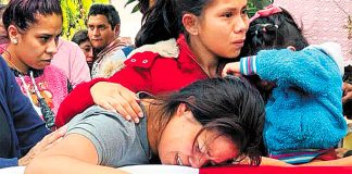 The widow of one of the slain officers at his funeral on Wednesday in Michoacán.