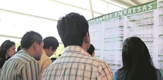 Job hunters check an employment board.