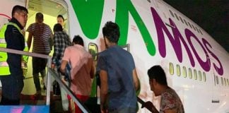 Undocumented migrants board their plane for India.